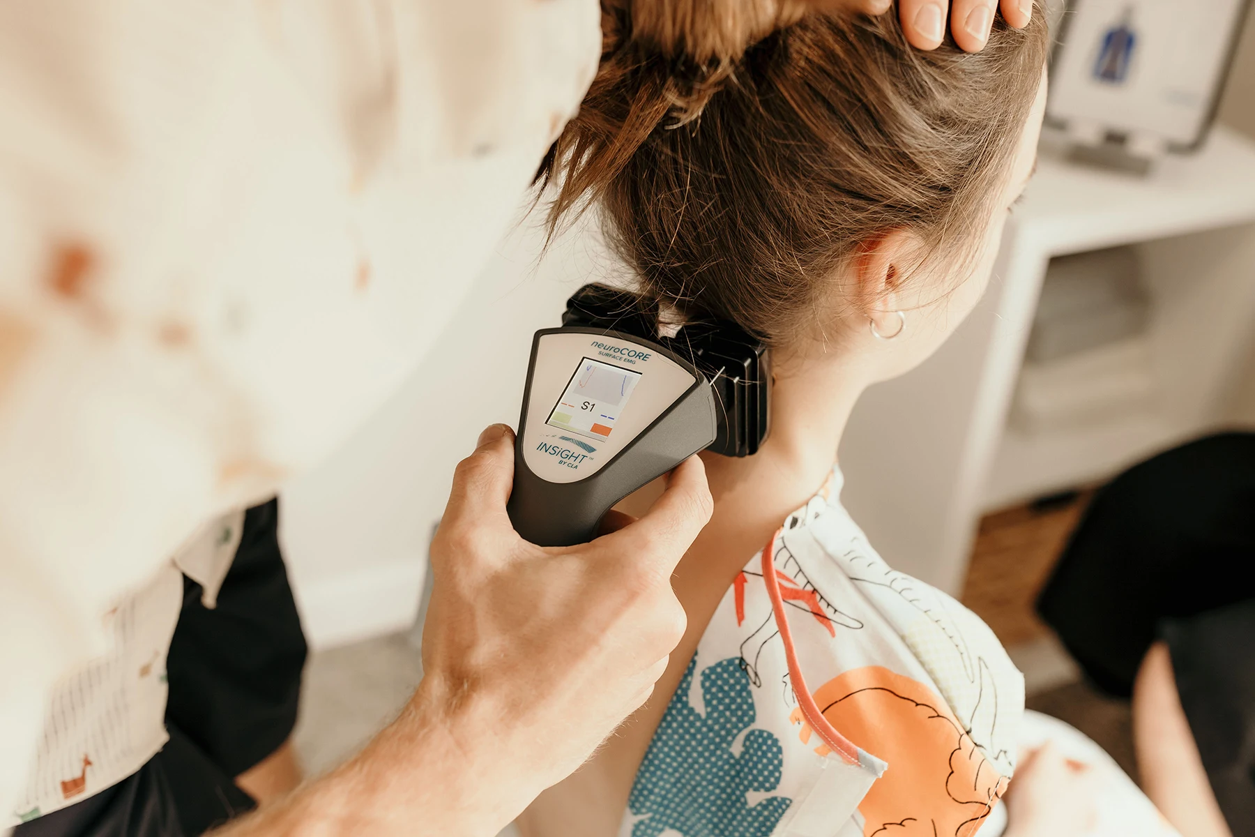 sEMG scan being performed on a child